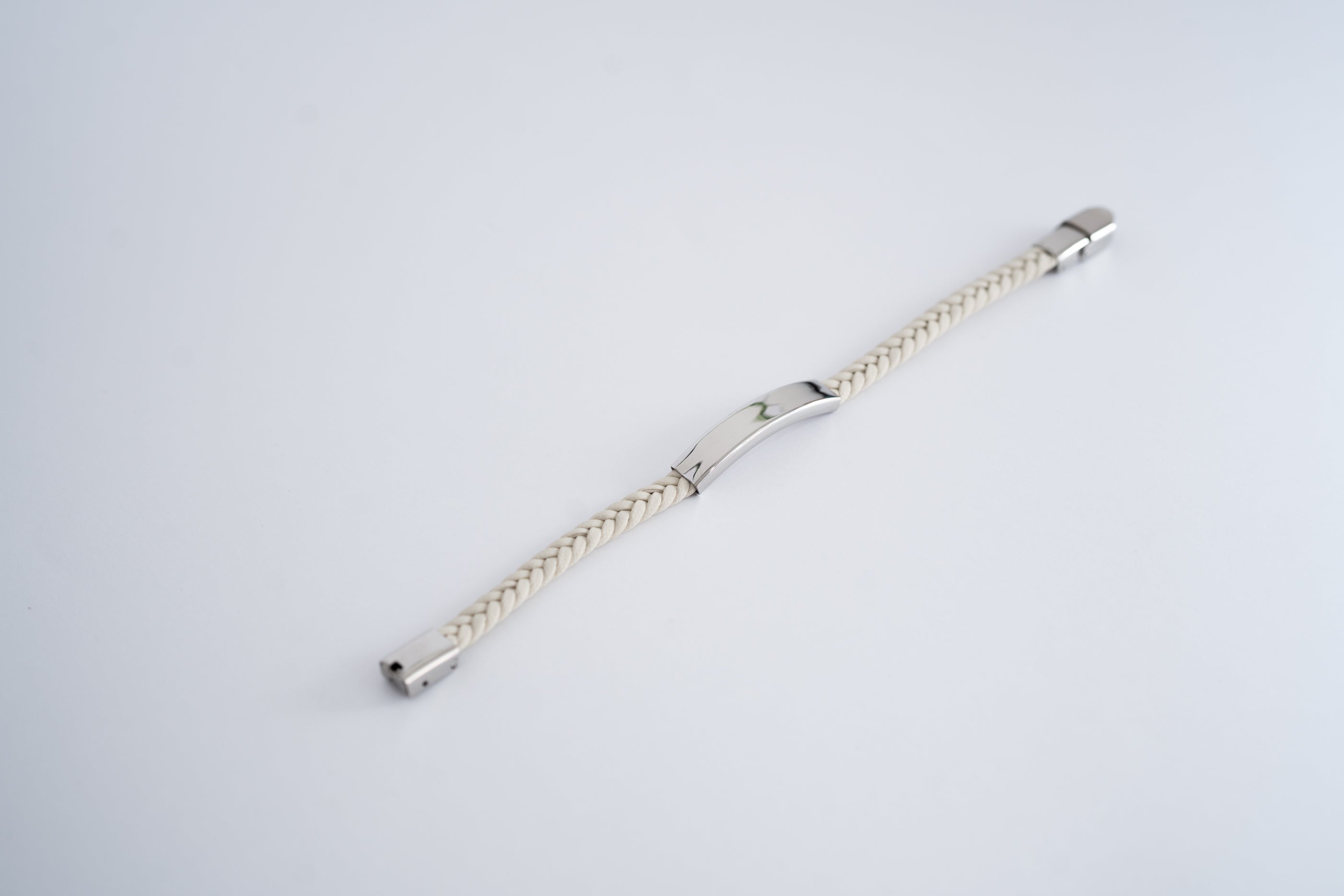 Braided bracelet with multicolor steel plate